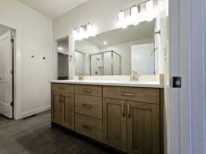 Bathroom featuring vanity, tile patterned flooring, and an enclosed shower