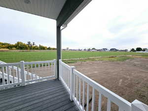 Deck with a lawn and a rural view