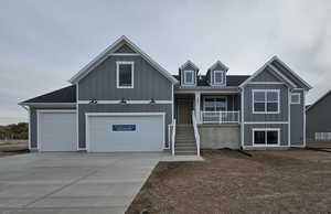 View of front of home featuring covered porch and a garage