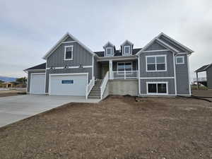 View of front of house with covered porch and a garage