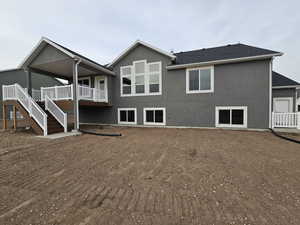 Rear view of property featuring a wooden deck