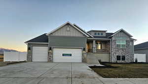 Craftsman house featuring a lawn and a garage