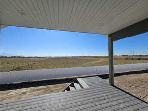 View of dock with a rural view and a deck