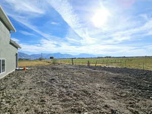 View of yard featuring a rural view and a mountain view