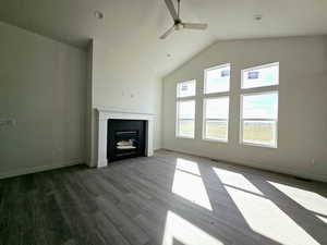 Unfurnished living room with lofted ceiling, wood-type flooring, and ceiling fan