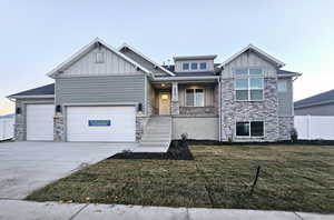 View of front of home featuring a garage and a front lawn