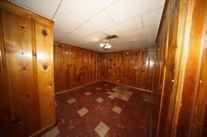 Basement featuring wood walls