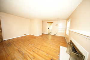 Unfurnished living room featuring hardwood / wood-style flooring