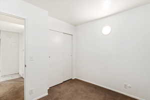 Unfurnished bedroom with a closet and carpet