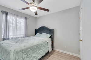 Bedroom featuring light wood-type flooring and ceiling fan