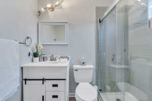 Bathroom with vanity, toilet, and walk in shower