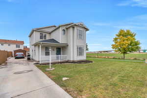 View of front of property featuring a front lawn and a garage