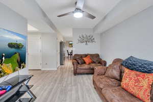 Living room featuring light wood-type flooring and ceiling fan