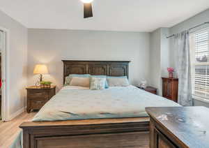 Bedroom featuring ceiling fan and hardwood / wood-style flooring