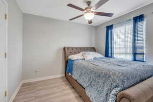 Bedroom featuring light hardwood / wood-style flooring and ceiling fan