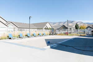View of community featuring a mountain view, a patio, and a residential view