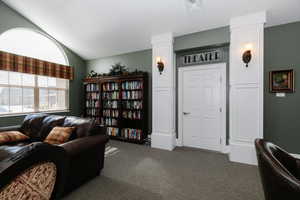 Living area featuring carpet and lofted ceiling