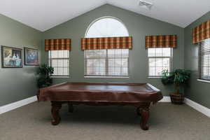 Playroom with vaulted ceiling, carpet, baseboards, and billiards