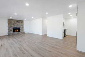 Living room featuring a stone fireplace and LVP