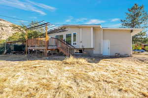 Rear view of property featuring a wooden deck