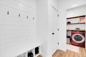 Mudroom featuring light wood-style floors and washer / clothes dryer