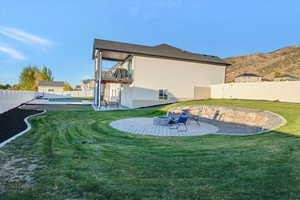 View of yard featuring a patio area, a mountain view, fire pit