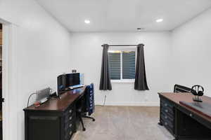 Home office with light colored carpet