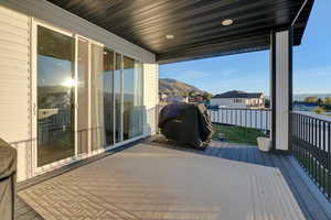 Deck with a mountain view and grilling area