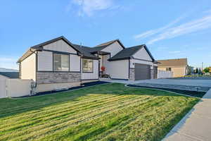 View of front of house with a front lawn and a garage