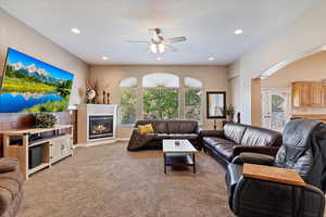 Living room with light carpet and ceiling fan