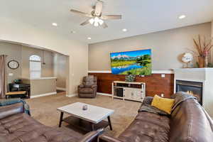 Carpeted living room with ceiling fan