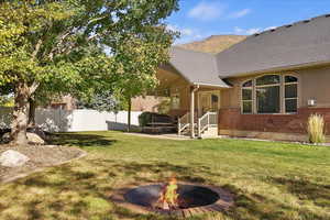 View of yard featuring an outdoor fire pit and a patio area