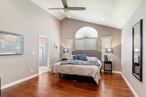 Bedroom featuring dark wood-type flooring, ceiling fan, high vaulted ceiling, and a textured ceiling