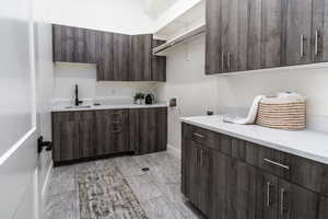 Laundry room with cabinets, washer hookup, hookup for an electric dryer, and sink