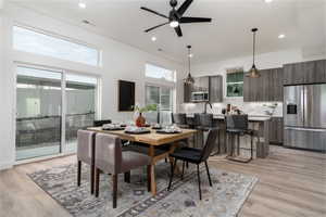 Dining area with ceiling fan and light hardwood / wood-style floors