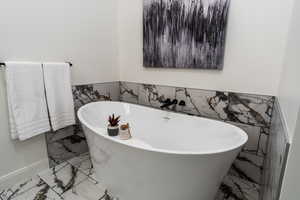 Bathroom featuring a tub to relax in