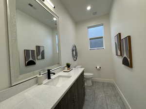 Bathroom featuring vanity and toilet