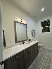 Bathroom featuring vanity and toilet