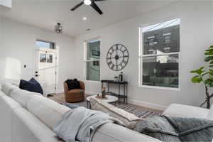 Living room with hardwood / wood-style floors and ceiling fan