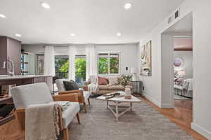 Living room with sink and light parquet floors