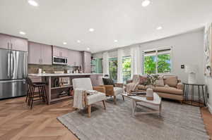 Living room featuring sink and light parquet flooring