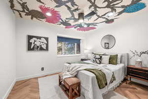 Bedroom with parquet floors and ceiling fan