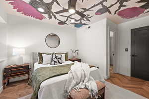 Bedroom with parquet floors and ceiling fan