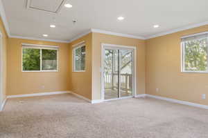 Family room with light carpet and crown molding