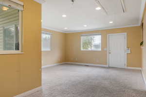 Family room with crown molding and carpet flooring