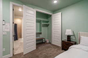 Carpeted bedroom with a closet and a textured ceiling