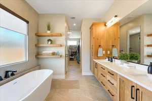 Bathroom with vanity and separate shower and tub