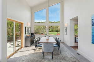 Dining space featuring a high ceiling, healthy amount of natural light, and baseboards