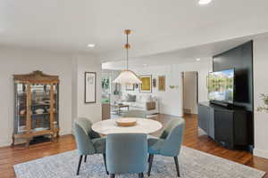 Dining area featuring dark wood finished floors, recessed lighting, and baseboards