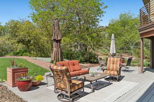 Wooden deck featuring an outdoor hangout area and outdoor dining area